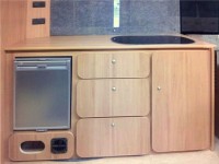 Closed kitchen sink and fridge in camper kitchen unit fitted by Céide Campervan Conversions, Co. Donegal, North-West Ireland