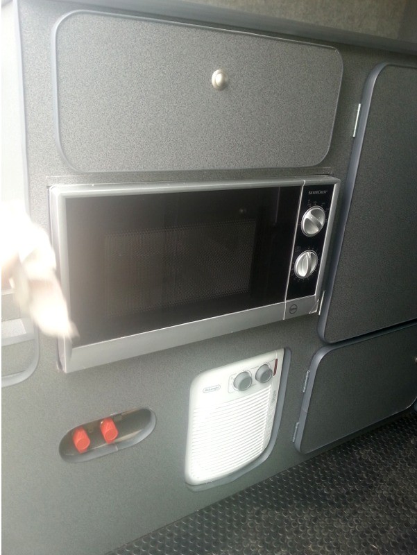 Close up of microwave oven and heater in van conversion by Céide Campervan Conversions, Donegal, Ireland