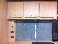 Overview of kitchen area with sink, fridge and oven fitted by Céide Campervan Conversions, Co. Donegal, North-West Ireland