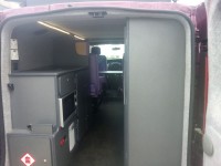 Overview of new campervan showing oven, heater and cupboards from rear of van fitted by Céide Campervan Conversions, Donegal, Ireland
