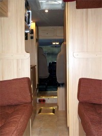 Seating - convertible to bedding - and view of the driving area in a camper conversion by Céide Campervan Conversions, Co. Donegal, Ireland