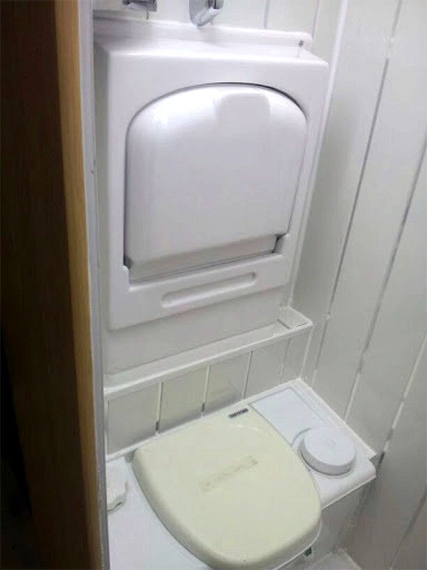 Toilet with fold up sink above for efficient use of space in van conversion by Céide Campervan Conversions, Co. Donegal,  Ireland